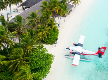 waterplane landing on a resort's beach side 