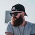 Profile picture of a guy wearin baseball cap with a big beard